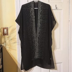 A black cover up use to give life to black dress for a night out.